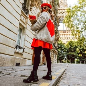 chunky cardigan boasting a giant red heart on the back.